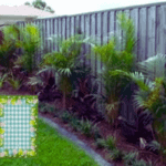 A standard-sized garden flag places along a garden pathway, perfect for medium-sized gardens