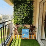 A mini garden flag decorating a small planter,suitable for balconies or compact spaces