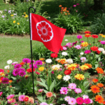 "Spring garden flag placed in the center of a vibrant flower bed."